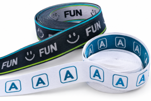 Custom jacquard elastic waistband webbing with woven A logos and FUN lettering.