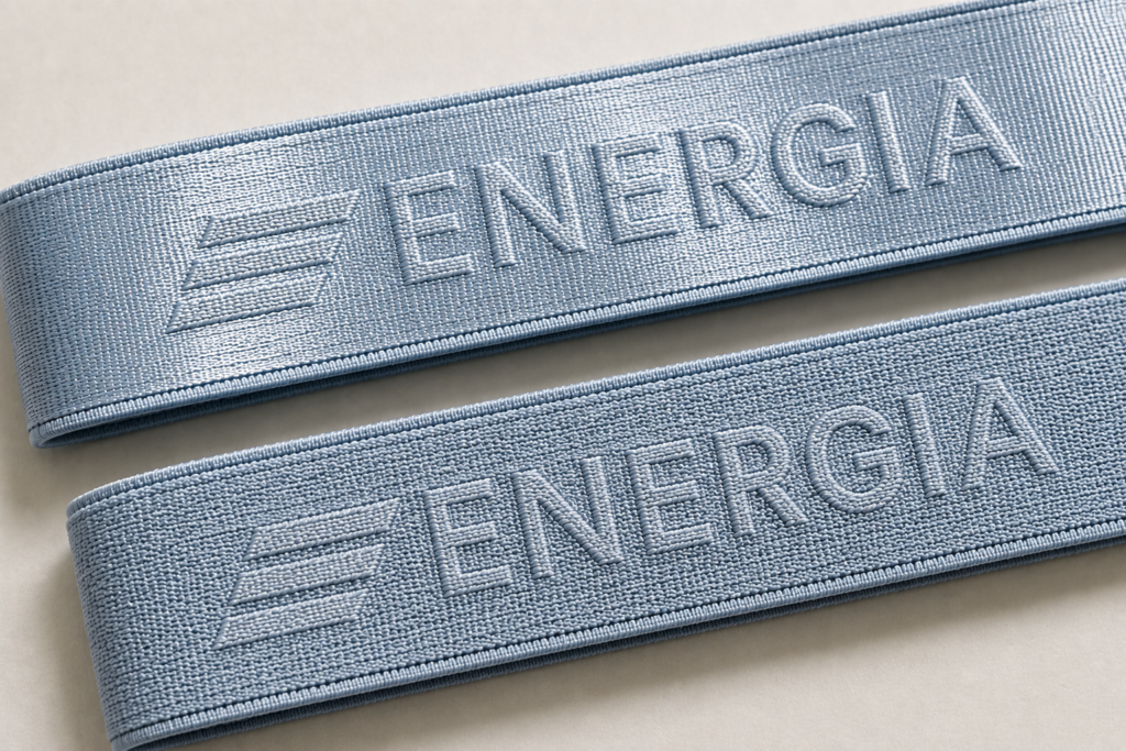 Light blue nylon and polyester sports bra straps with the same woven logo showing different surface appearance