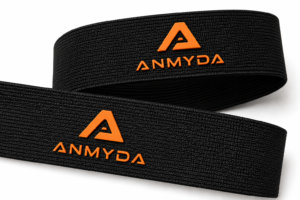 Black polyester webbing with raised orange silicone logos on the surface