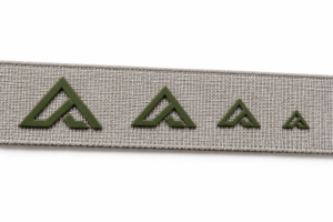 Same raised silicone logo printed in progressively smaller sizes on webbing