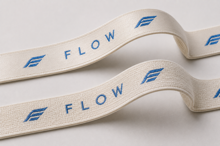 Sports bra elastic straps with the same woven logo showing different material and surface structures