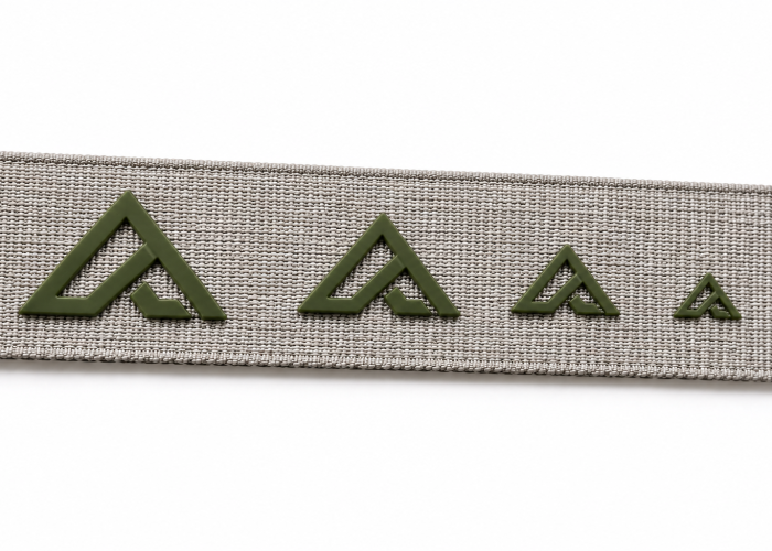Same raised silicone logo printed in progressively smaller sizes on webbing
