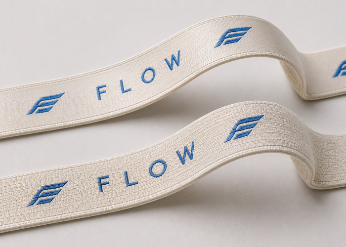 Sports bra elastic straps with the same woven logo showing different material and surface structures