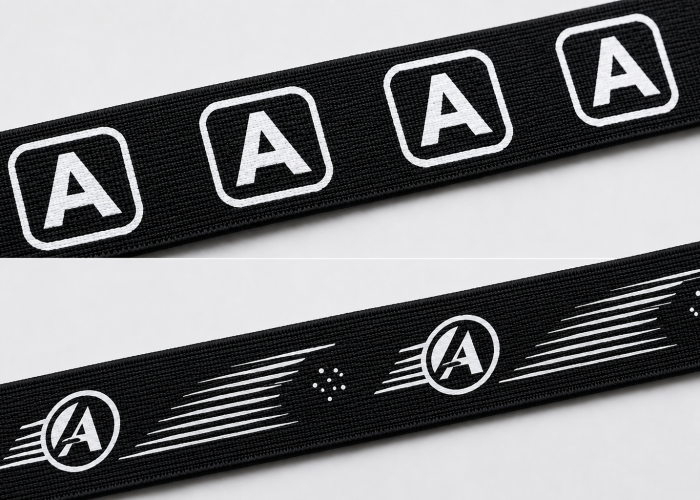 Simple and complex white screen printed logo designs compared on black woven webbing.
